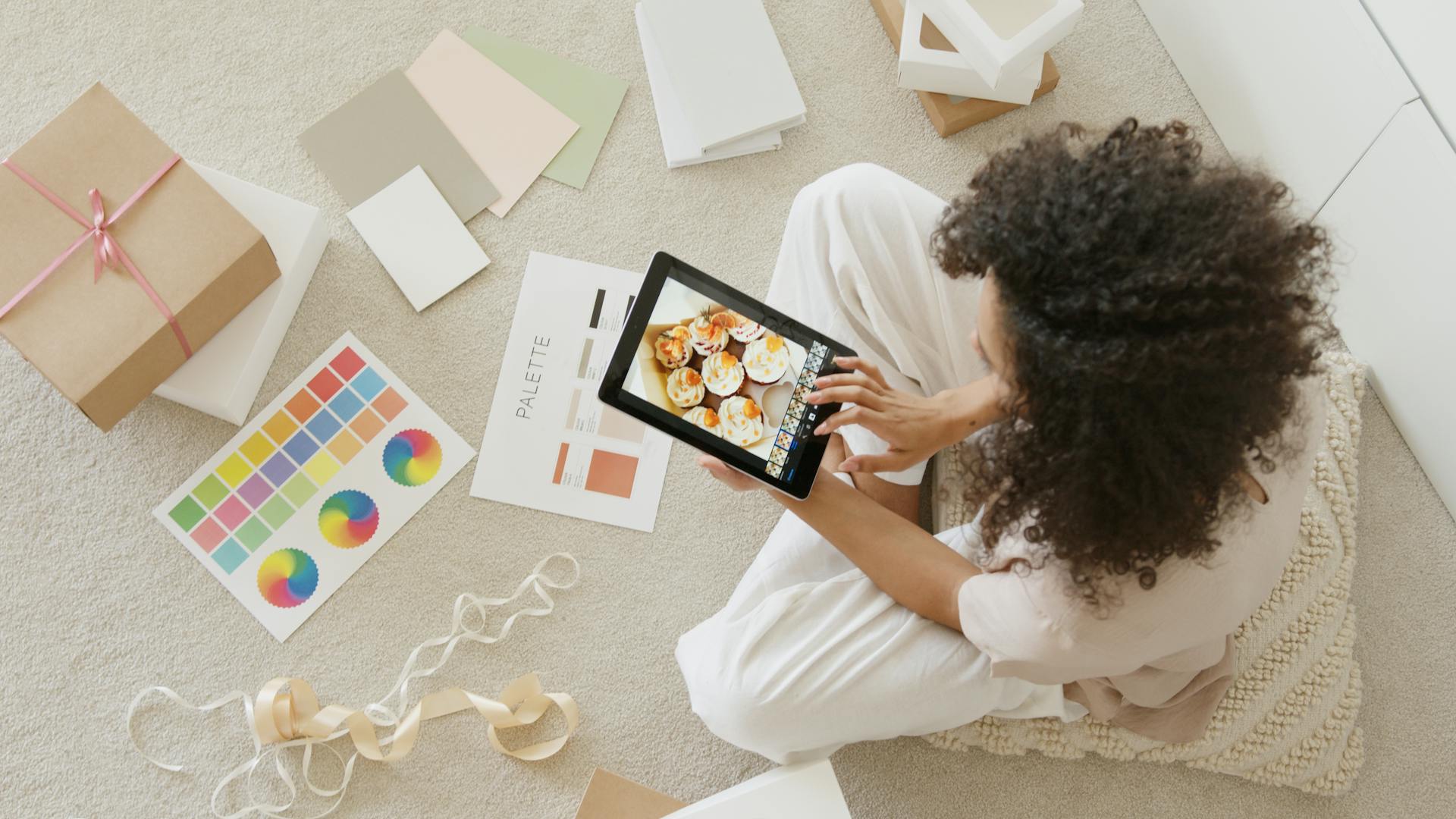 video-marketing-for-small-business-woman sitting and editing photos on her tablet