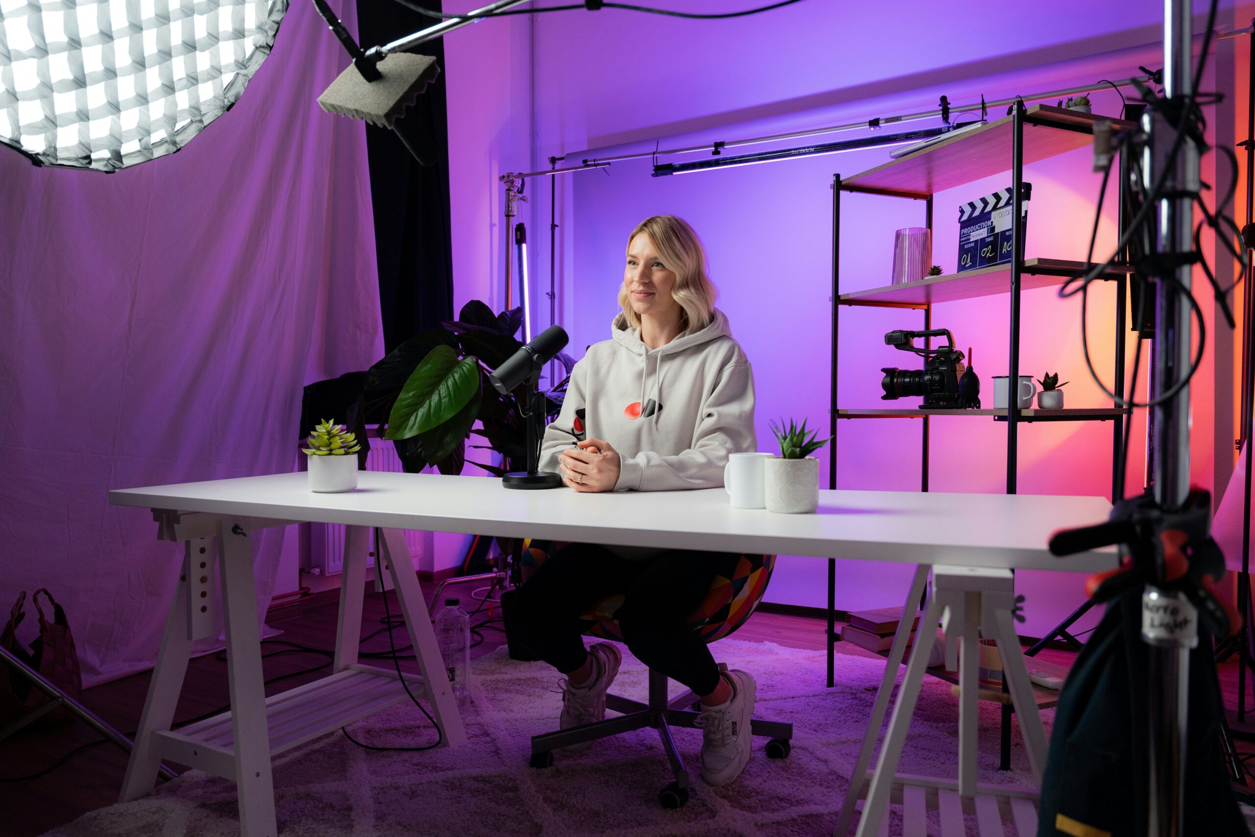 video-marketing-trends-ecommerce-woman recording a video in a purple light background